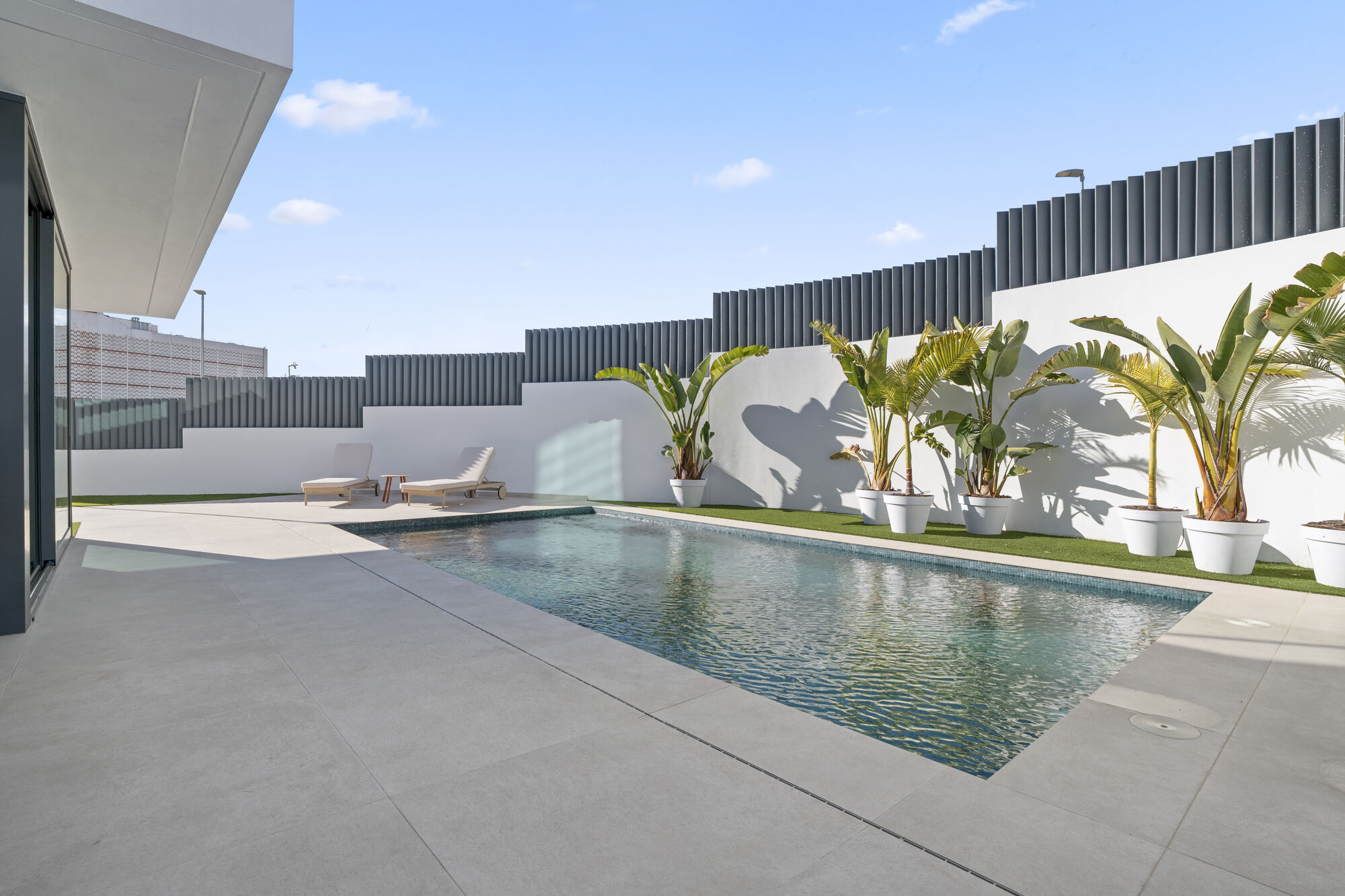 Best Luxury New-Build Developments on the Costa Blanca (2026) 11 Private pool terrace with palms and loungers at the Villa 26 show villa, Villas de Loix, Benidorm