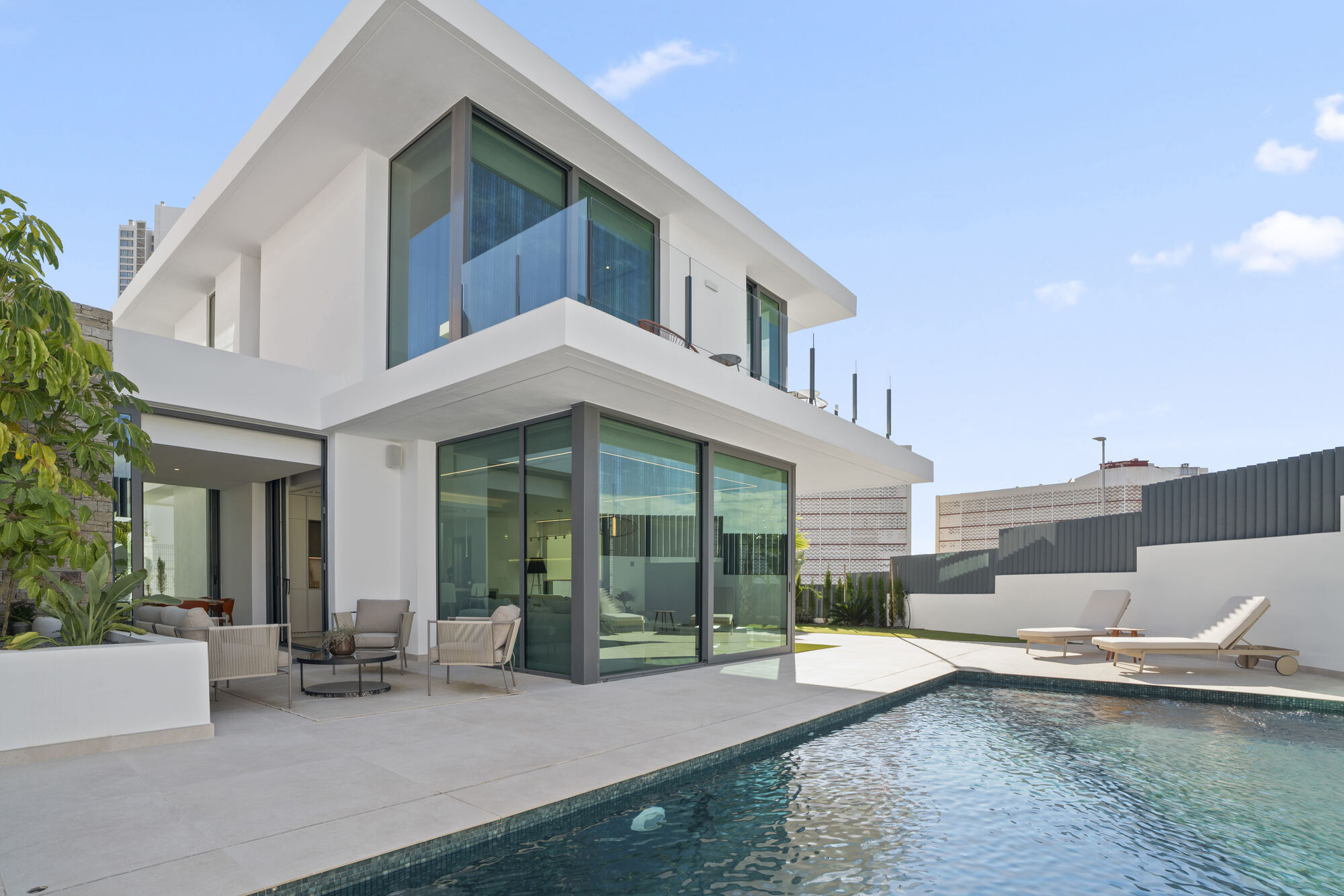 Best Luxury New-Build Developments on the Costa Blanca (2026) 1 Villa 26 at Villas de Loix in Benidorm: a two-storey white villa with floor-to-ceiling glazing and a private pool